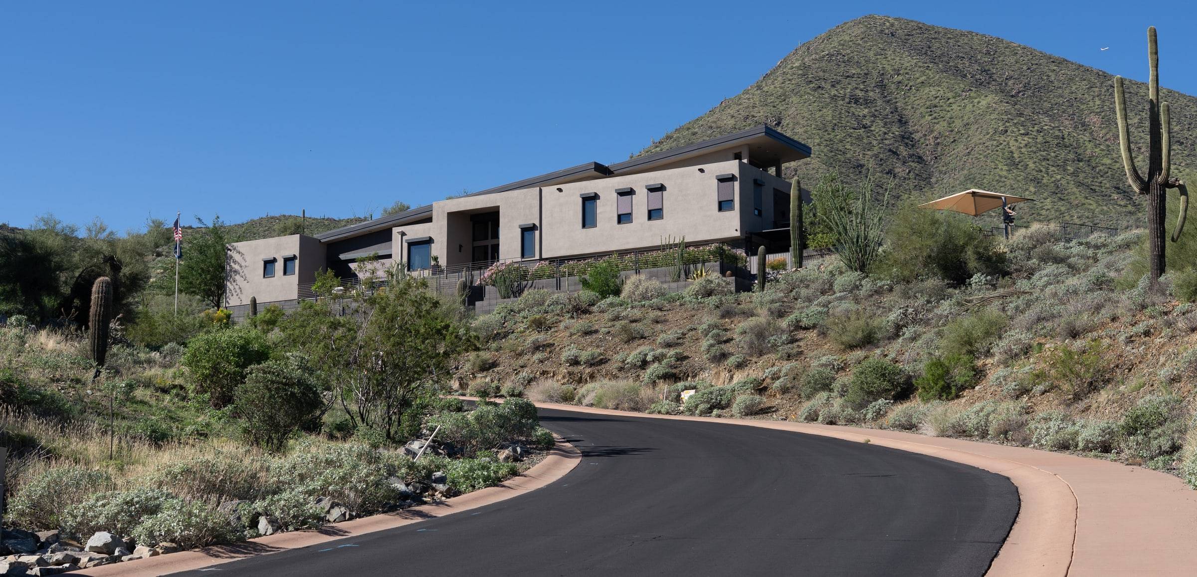 Contemporary flat-roof desert home with saguaro and mountain views
