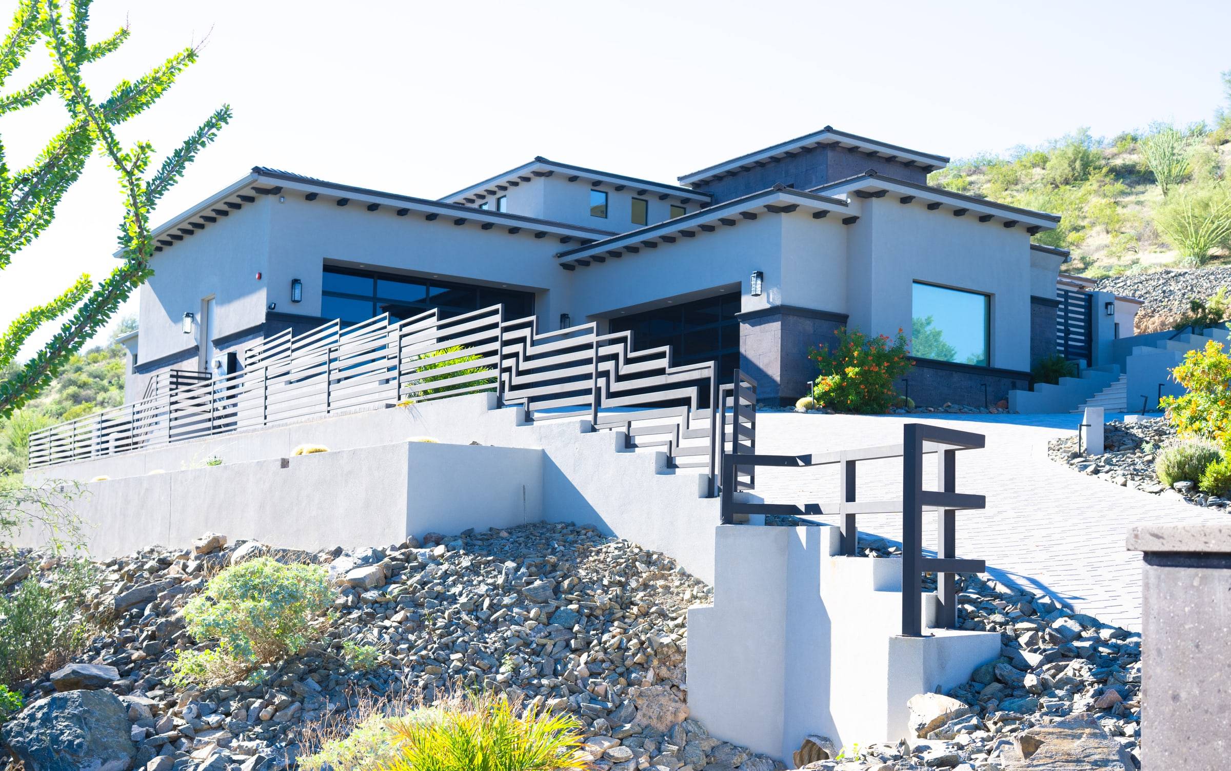 Contemporary modern home — terraced desert hillside with horizontal rails