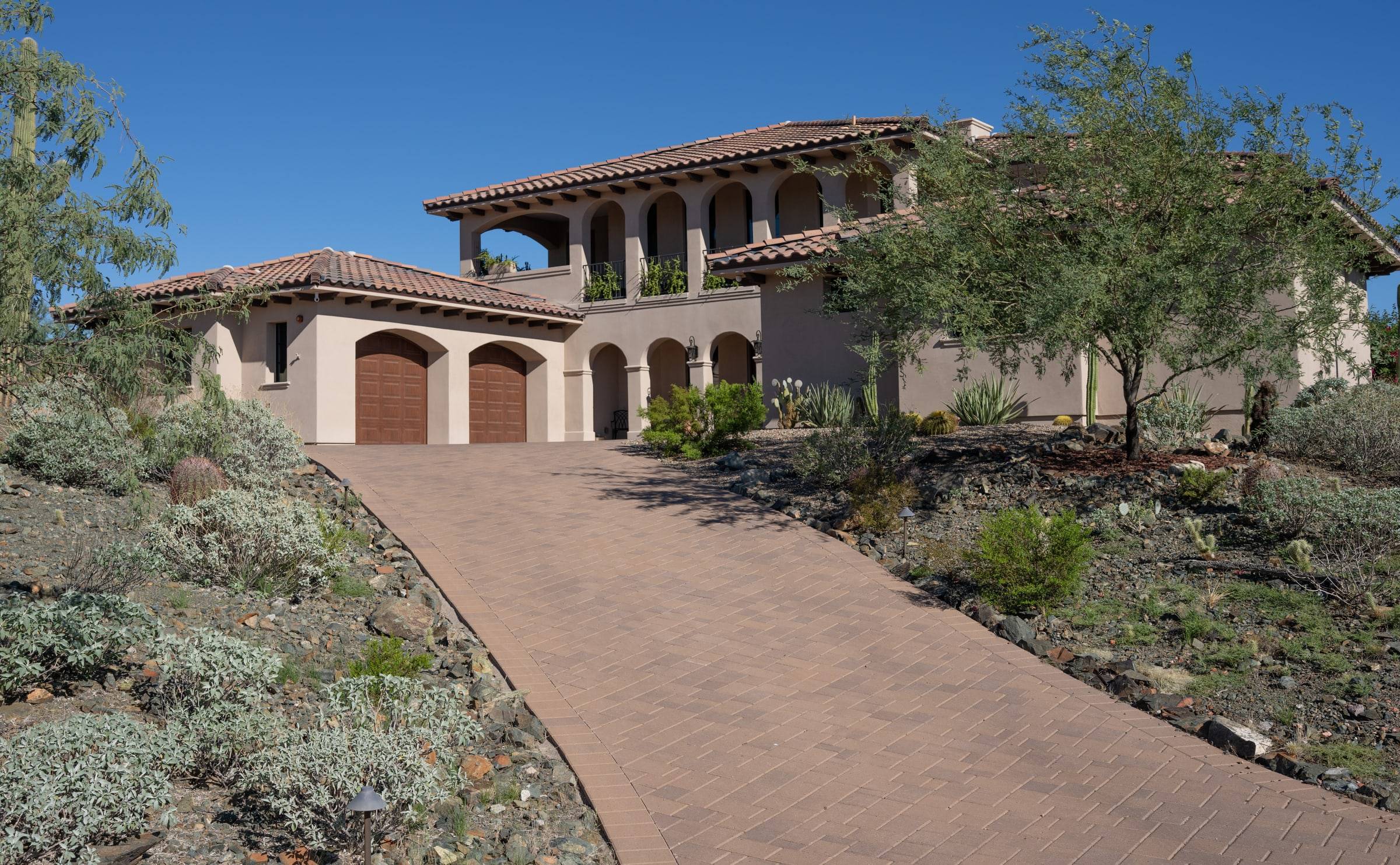 Mediterranean estate with arched garage and paver driveway — Eagles Nest