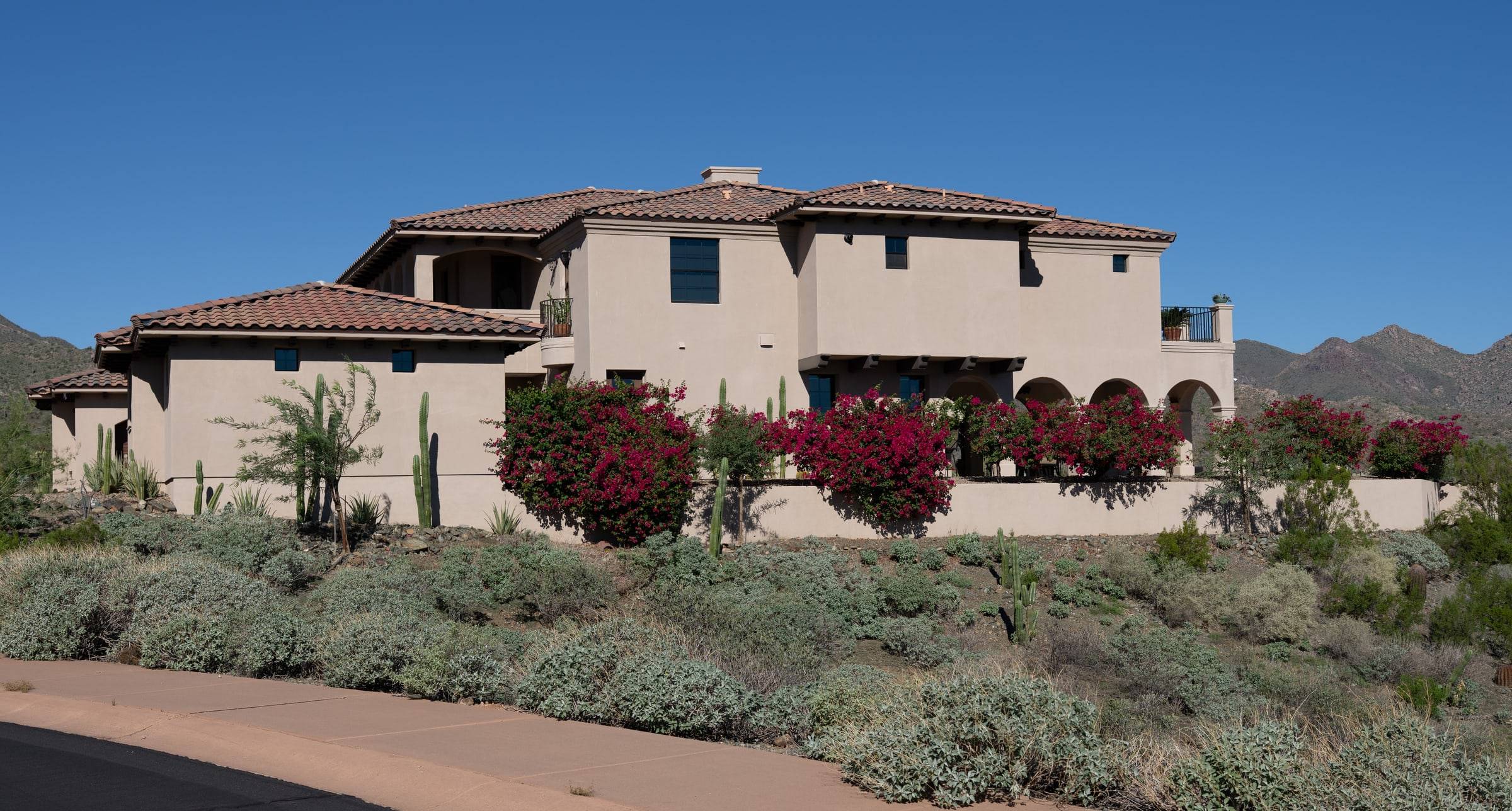 Mediterranean home with bougainvillea and mountain views