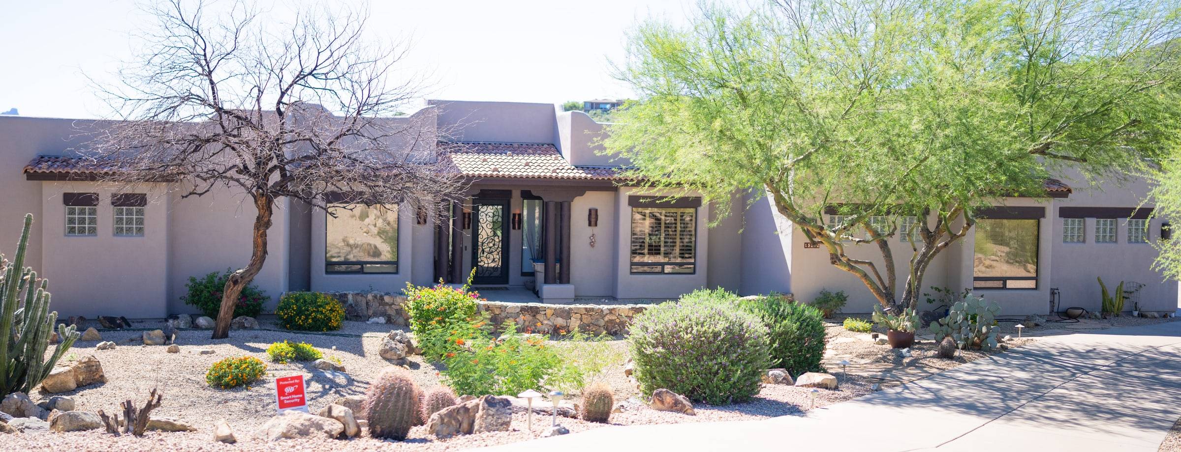 Southwest pueblo-style home with desert landscaping